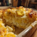 A close-up of a Cheesy Squash Casserole, showing golden-brown melted cheese and tender squash slices.