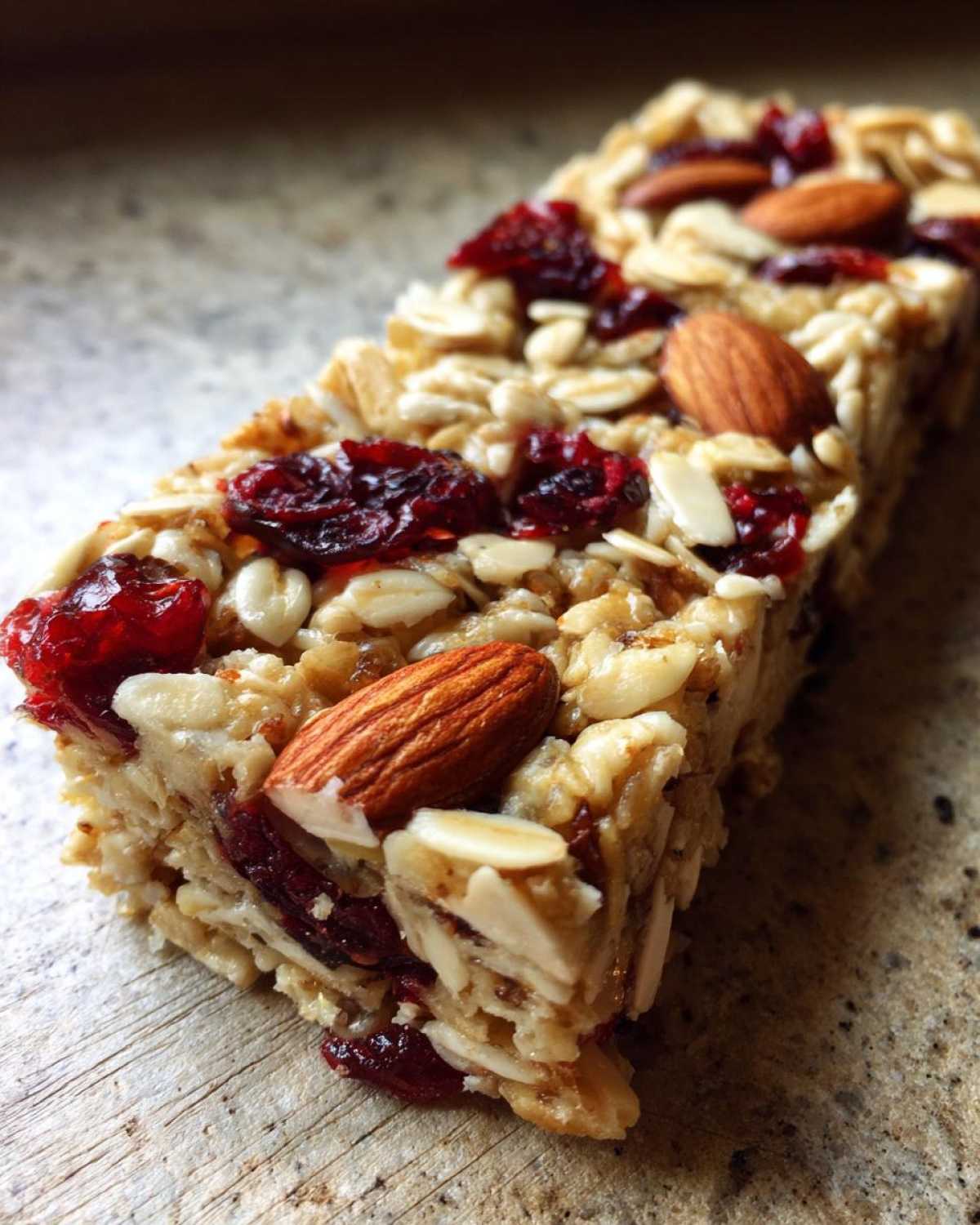 Close-up of a Cherry Almond Energy Bar showing oats, almonds, and dried cherries.