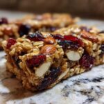 Close-up of a homemade Cherry Almond Energy Bar, packed with oats, dried cherries, and almonds.