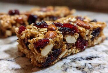 Close-up of a homemade Cherry Almond Energy Bar, packed with oats, dried cherries, and almonds.