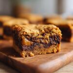 A close-up of a rich Cookie Butter Blondie with a gooey caramel swirl and chocolate chips.