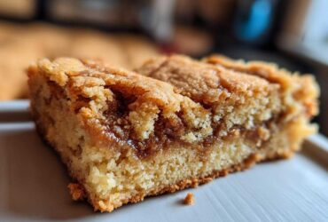Close-up of a rich, golden Cookie Butter Blondie with a visible swirl of cookie butter.
