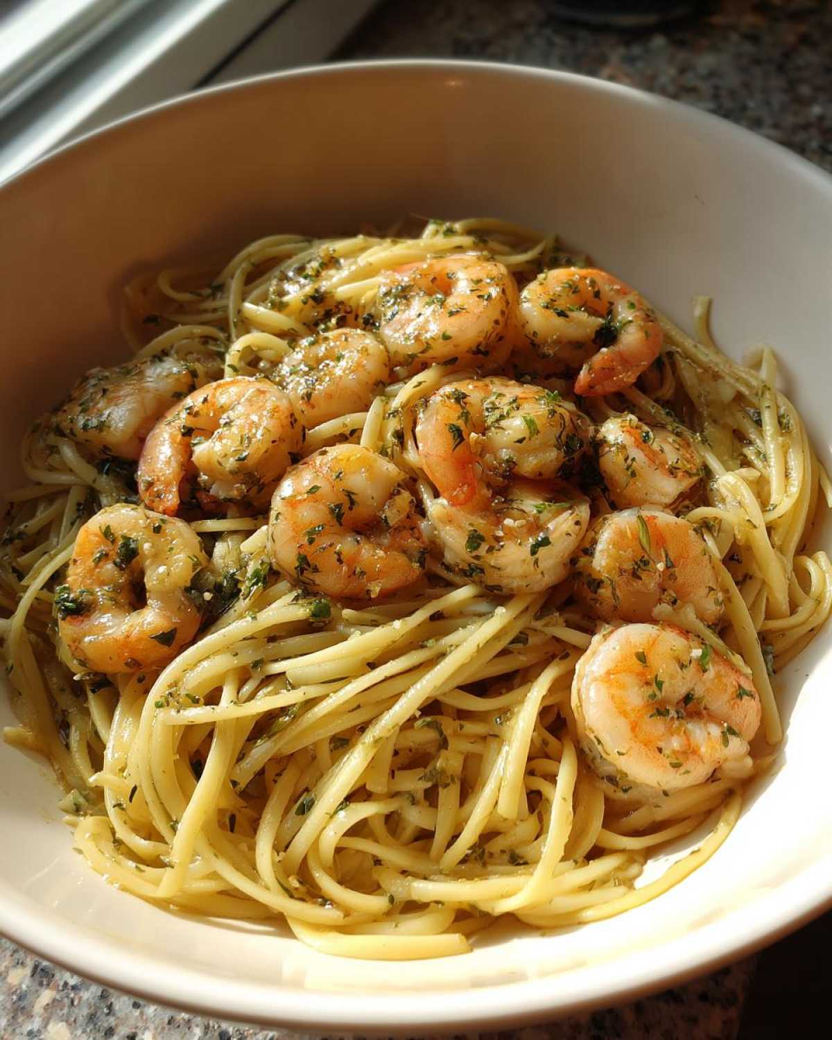 A close-up of Garlic Herb Shrimp Scampi served over linguine pasta, garnished with fresh parsley.