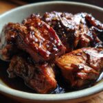 Close-up of tender Instant Pot Balsamic Chicken pieces coated in a glossy balsamic glaze, served in a bowl.