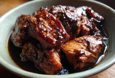 Close-up of tender Instant Pot Balsamic Chicken pieces coated in a glossy balsamic glaze, served in a bowl.