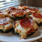 A plate of delicious Keto Zucchini Pizza Bites topped with melted cheese and pepperoni.