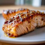 Close-up of a flaky, perfectly cooked Maple Dijon Salmon fillet with a glistening glaze.