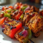 Close-up of grilled Mediterranean Chicken Kabobs with red and green bell peppers and red onion.