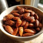 A close-up of a bowl filled with delicious Smoky Paprika Almonds, seasoned and ready to eat.