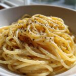 Close-up of creamy Spaghetti Cacio e Pepe, a classic Roman pasta dish with black pepper.