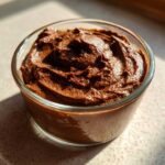 A close-up of rich, dark Vegan Chocolate Avocado Mousse served in a glass bowl.