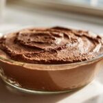 A close-up of a glass bowl filled with rich, creamy Vegan Chocolate Avocado Mousse.