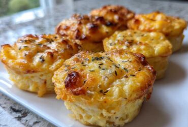 Close-up of baked cottage cheese egg cups starbucks recipe, topped with melted cheese and herbs.