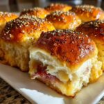 Close-up of freshly baked Ham and Cheese Sliders with melted cheese and everything bagel seasoning.