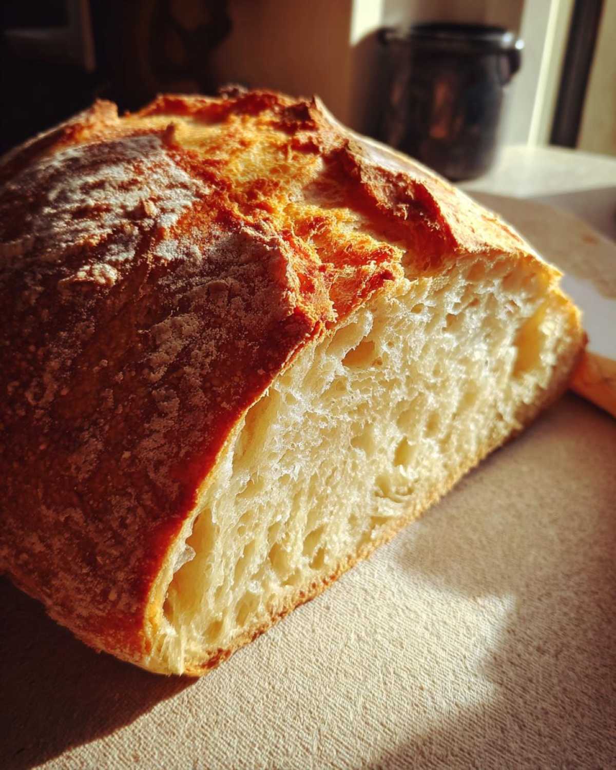 Close-up of the airy crumb and golden crust of freshly baked Italian bread.