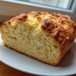 A close-up view of the soft, golden interior crumb of a freshly baked soda bread loaf.