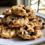 A tempting stack of freshly baked almond joy cookies loaded with chocolate chips and almonds.