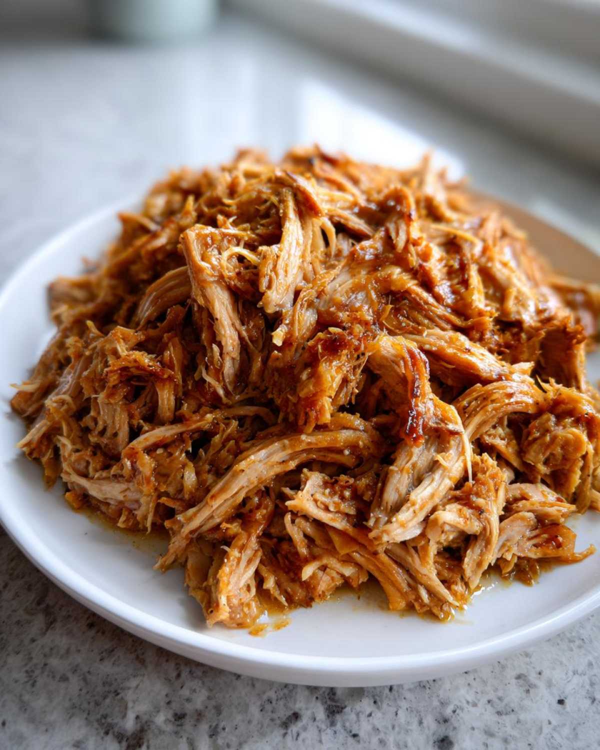 Close-up of tender, shredded pork meat ready to be served with pork and sauerkraut.
