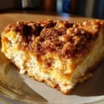 Close-up of a thick slice of Gluten-Free Cinnamon Crunch French Toast with a rich, crumbly cinnamon topping.