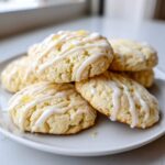 A stack of soft Gluten-Free Lemon Ricotta Cookies drizzled with white icing and lemon zest.