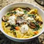 A close-up of a bowl of One-Pot Creamy Spinach Mushroom Lasagna Soup topped with ricotta and Parmesan.