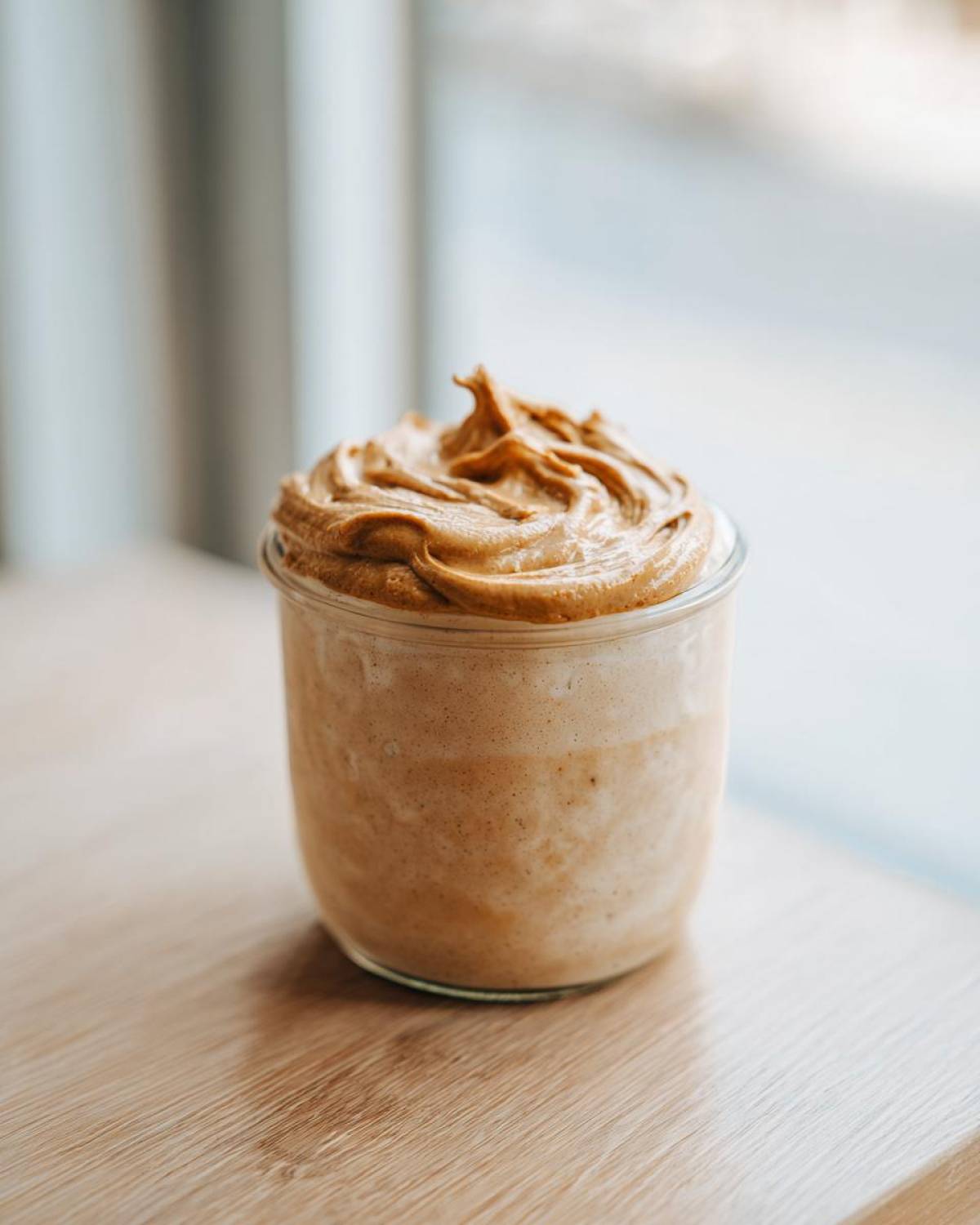 Close-up of Vegan Peanut Butter Banana Overnight Oats topped with swirled peanut butter mixture.