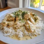 Close-up of Dump-and-Bake Chicken Tzatziki served over fluffy white rice and garnished with fresh dill.