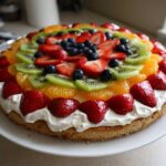 A vibrant Easy Fruit Pizza featuring a sugar cookie crust, whipped topping, and colorful fresh fruit.