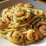 Close-up of Quick Garlic Butter Shrimp Scampi Pasta tossed with shrimp, garlic, and parsley in a white bowl.