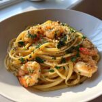 A bright, close-up shot of Quick Garlic Butter Shrimp Scampi Pasta tossed in a rich sauce and topped with fresh parsley.