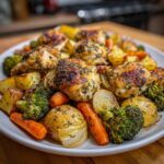 Platter of Sheet Pan Lemon Herb Roasted Chicken Pieces and Veggies including potatoes, carrots, and broccoli.